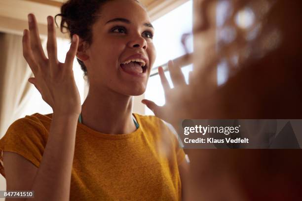 close-up young women talking, while sitting in bunk bed - speaking explaining young woman stock-fotos und bilder