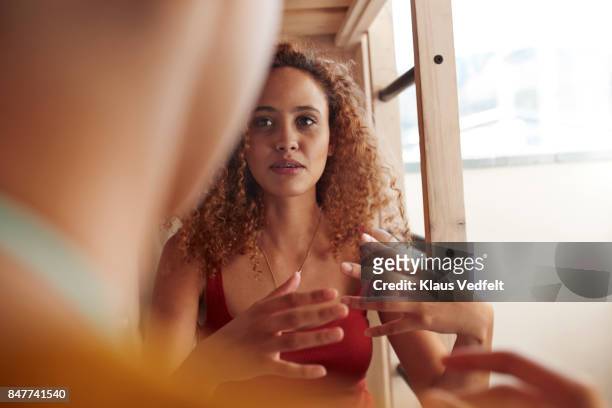 close-up young women talking, while sitting in bunk bed - gesturing foto e immagini stock