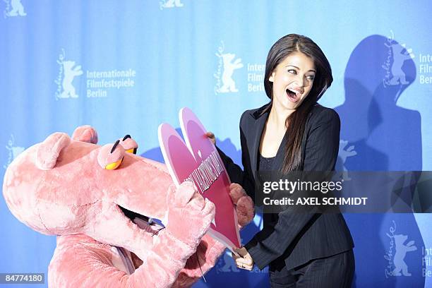 Indian actress Aishwarya Rai Bachchan bursts in laughter as a performer dressed in a Pink Panther costume offers her a Valentine Day's gift during a...