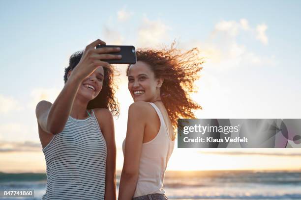 young women making selfie on the beach - autorretratarse fotografías e imágenes de stock