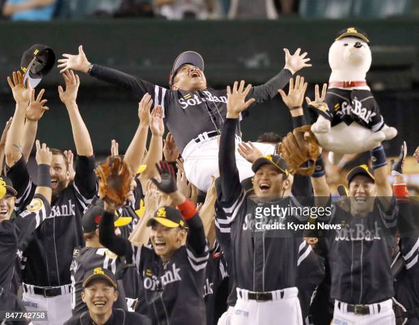 SoftBank Hawks manager Kimiyasu Kudo receives a victorious toss as his team won the franchise's 18th Pacific League title on Sept. 16 by beating the...