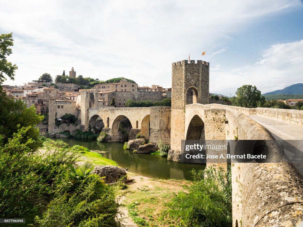 Sight of the people and Besalu medieval bridge to the late afternoon, in the province of Girona, Catalonia, Spain