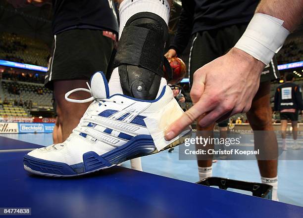 Handballer puts resin on his shoe before the Toyota Handball Bundesliga match between Rhein Neckar Loewen and Fuechse Berlin at the SAP-Arena on...