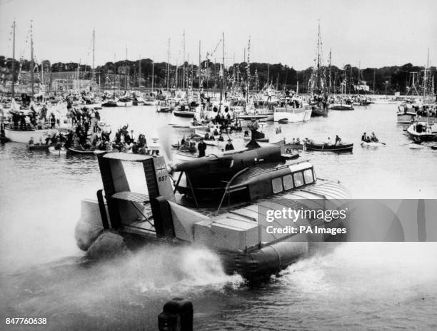 *Scanned low-res from print, high-res available on request* Queen Elizabeth II and the Duke of Edinburgh leaves the crowded harbour at Yarmouth, Isle...