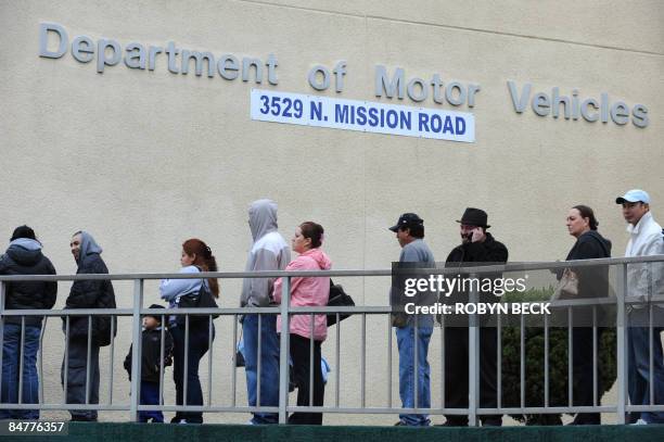 People wait in line outside of the State of California Department of Motor Vehicles in Los Angeles, California on February 13, 2009. The DMV, already...