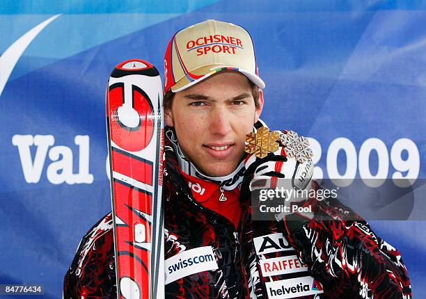 Gold medal winner Carlo Janka of Switzerland celebrates following the Men's Giant Slalom event held on the Face de Bellevarde course on February 13,...
