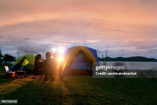 group of young asian camper enjoy camping outdoors . holiday , vacation , summer concept . - campfire stories stock pictures, royalty-free photos & images