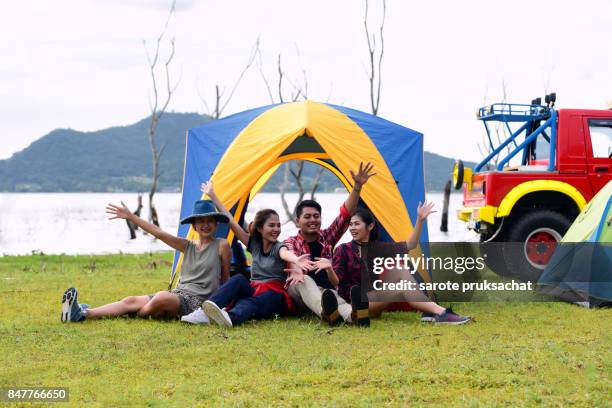 group of young asian camper enjoy camping outdoors . holiday , vacation , summer concept . - campfire stories stock pictures, royalty-free photos & images