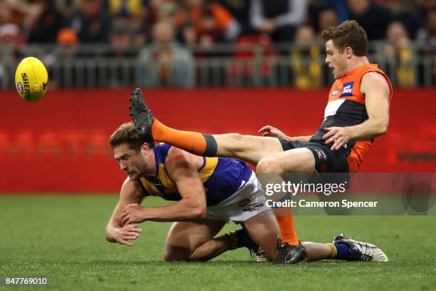 Heath Shaw of the Giants kicks over Mark Hutchings of the Eagles during the AFL First Semi Final match between the Greater Western Sydney Giants and...