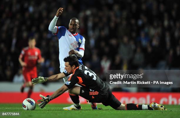 Liverpool's goalkeeper Alexander Doni fouls Blackburn Rovers' David Hoilett in the area to give away a penalty and receive a red card