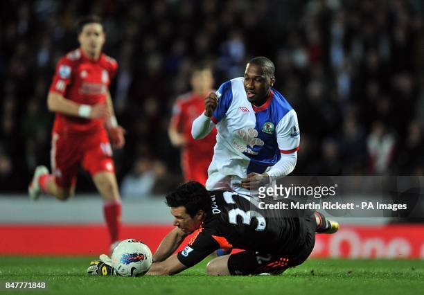 Liverpool's goalkeeper Alexander Doni fouls Blackburn Rovers' David Hoilett in the area to give away a penalty and receive a red card