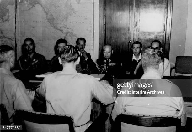 Vice Chief of the Imperial Japanese Army General Staff Lieutenant General Torashiro Kawabe sits with his delegation as they negotiate arrange terms...