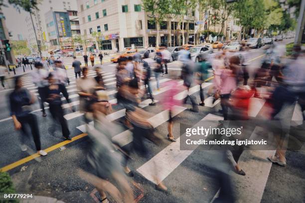 people on pedestrian crossing in bussnies area gangnam, seoul. - south korea business stock pictures, royalty-free photos & images