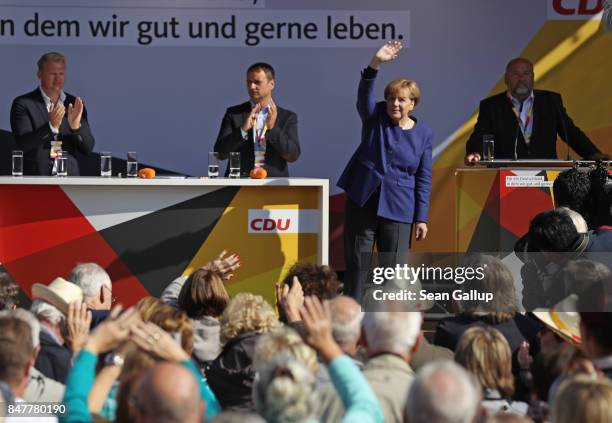 German Chancellor and Chrstian Democrat Angela Merkel waves after speaking at an election campaign stop on the island of Ruegen on September 16, 2017...