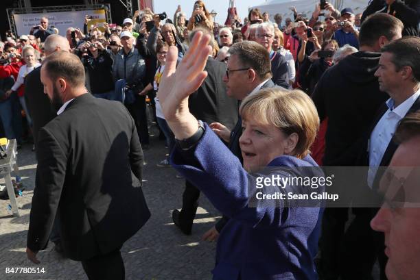 German Chancellor and Chrstian Democrat Angela Merkel greets supporters upon her arrival at an election campaign stop on the island of Ruegen on...