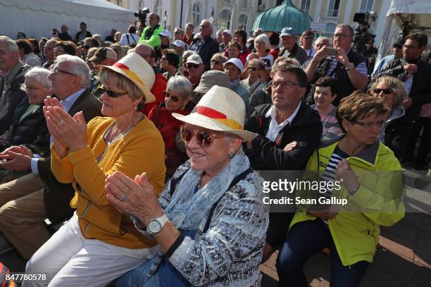 People attend an election campaign stop of German Chancellor and Chrstian Democrat Angela Merkel on the island of Ruegen on September 16, 2017 in...