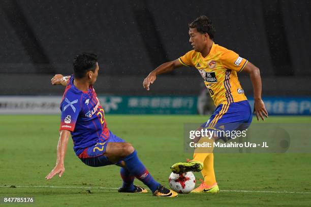 Gakuto Notsuda of Vegalta Sendai is tackled by Yuhei Tokunaga of FC Tokyo during the J.League J1 match between FC Tokyo and Vegalta Sendai at...