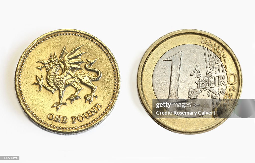 One pound and one euro coin side by side.