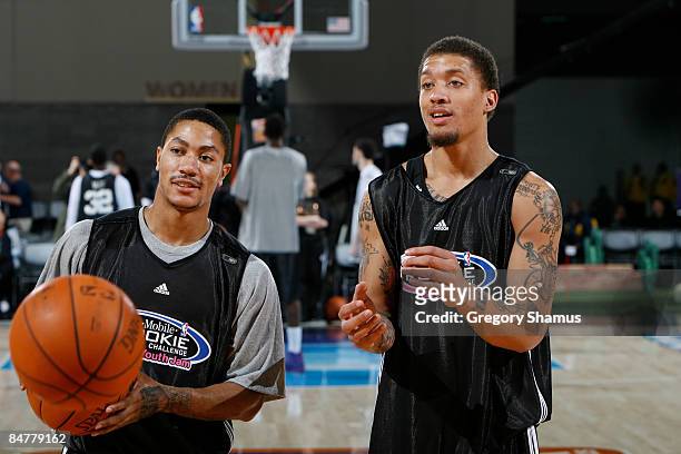 Derrick Rose of the Chicago Bulls and Michael Beasley of the Miami Heat watch during the Rookie/Sophomore practice on center court during NBA Jam...