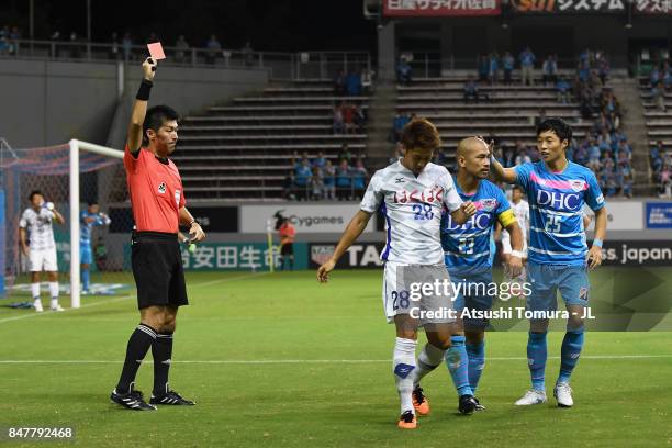 Yuki Hashizume of Ventforet Kofu is shown a red card by referee Yusuke Araki during the J.League J1 match between Sagan Tosu and Ventforet Kofu at...