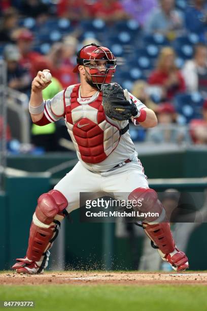 Cameron Rupp of the Philadelphia Phillies throws to second base during a baseball game against the Washington Nationals at Nationals Park on...