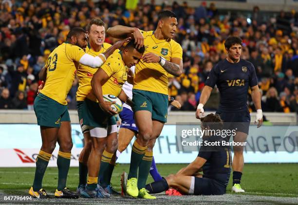 Will Genia of the Wallabies is congratulated by Israel Folau and his teammates after scoring a try during The Rugby Championship match between the...