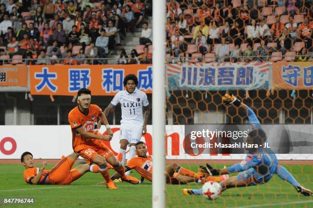 Leandro of Kashima Antlers scores his side's third and hat trick goal past Koki Otani of Albirex Niigata during the J.League J1 match between Albirex...