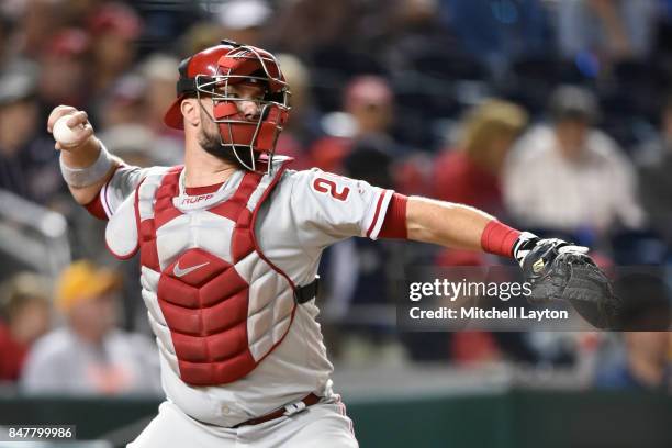 Cameron Rupp of the Philadelphia Phillies throws to second base during a baseball game against the Washington Nationals at Nationals Park on...