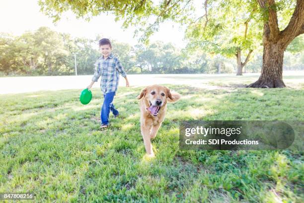 a boy and his dog - dog following stock pictures, royalty-free photos & images