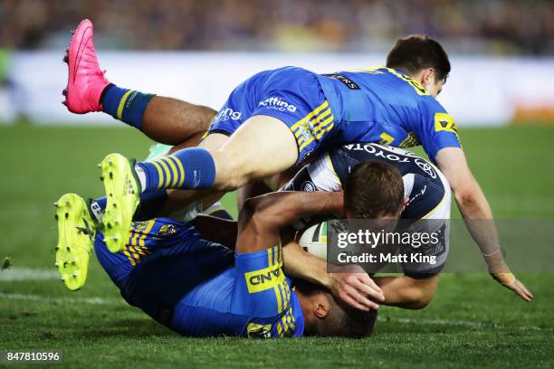 Gavin Cooper of the Cowboys is tackled during the NRL Semi Final match between the Parramatta Eels and the North Queensland Cowboys at ANZ Stadium on...