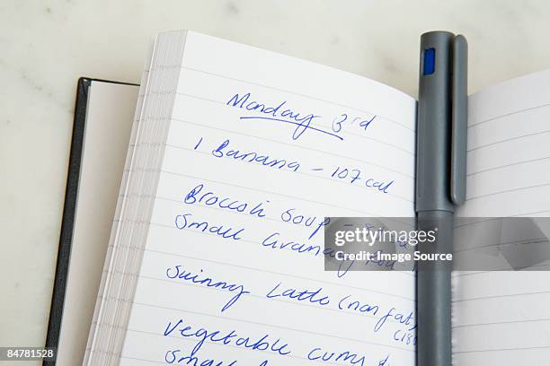 food diary and pen - diet journal stockfoto's en -beelden