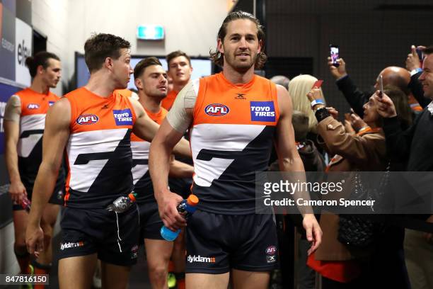 Callan Ward of the Giants and team mates walk into their changeroom after winning the AFL First Semi Final match between the Greater Western Sydney...
