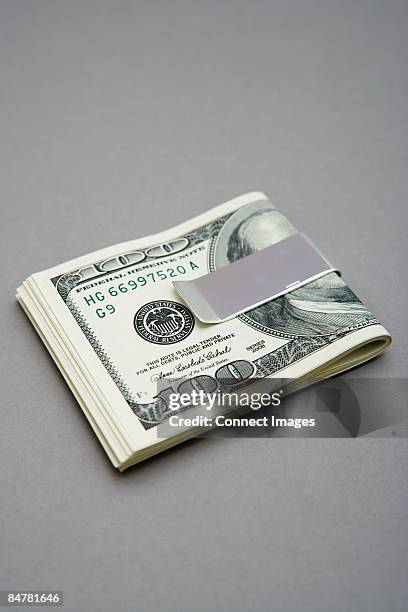 one hundred dollar bills in money clip - money clip stock pictures, royalty-free photos & images