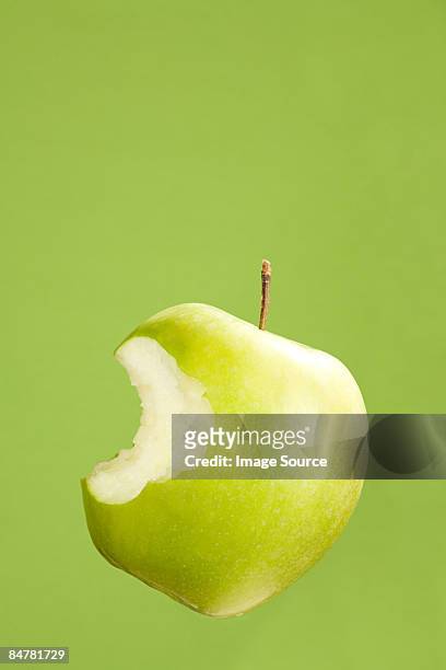 apple with missing bite - apple bite out stock pictures, royalty-free photos & images