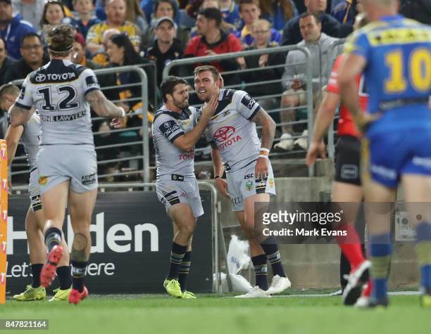 Kyle Feldt of the Cowboys, right, celebrates a try with Lachlan Coote during the NRL Semi Final match between the Parramatta Eels and the North...
