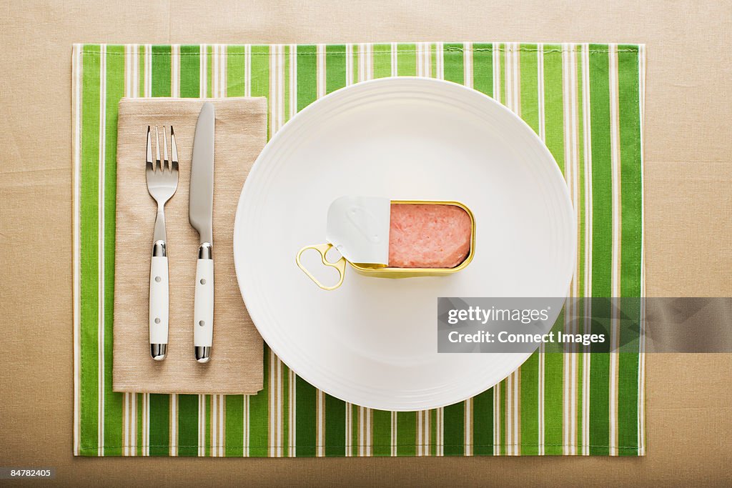 A can of ham on a plate