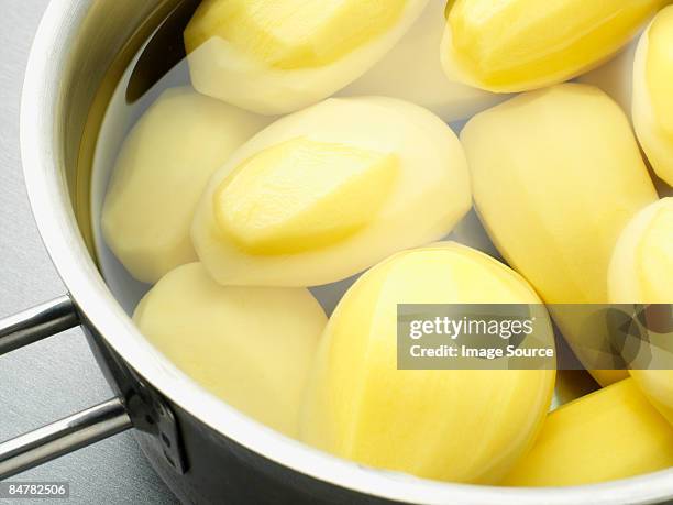 potatoes in a saucepan - boiling stockfoto's en -beelden