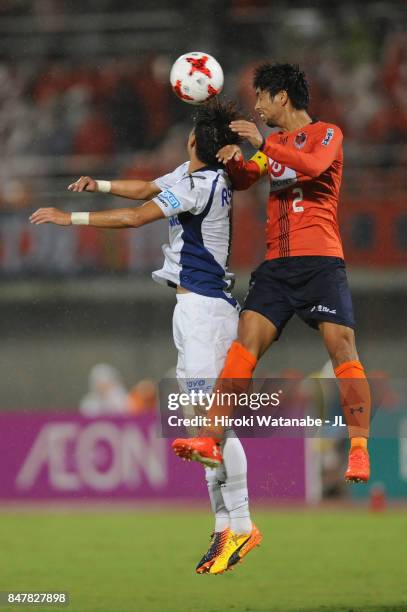 Hwang Ui Jo of Gamba Osaka and Kosuke Kikuchi of Omiya Ardija compete for the ball during the J.League J1 match between Omiya Ardija and Gamba Osaka...