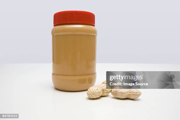 jar of peanut butter and peanuts - peanut butter stock pictures, royalty-free photos & images