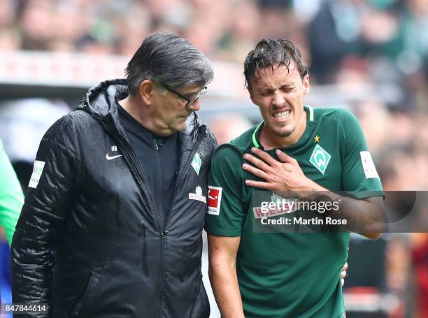 Max Kruse of Bremen has to leave the match injured during the Bundesliga match between SV Werder Bremen and FC Schalke 04 at Weserstadion on...