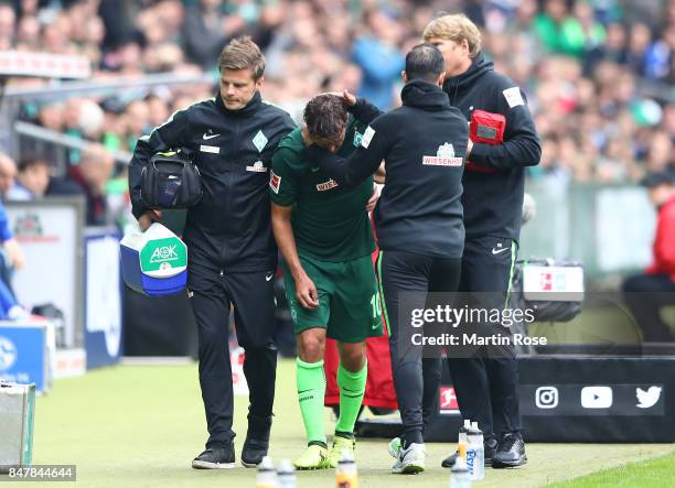 Max Kruse of Bremen has to leave the match injured during the Bundesliga match between SV Werder Bremen and FC Schalke 04 at Weserstadion on...