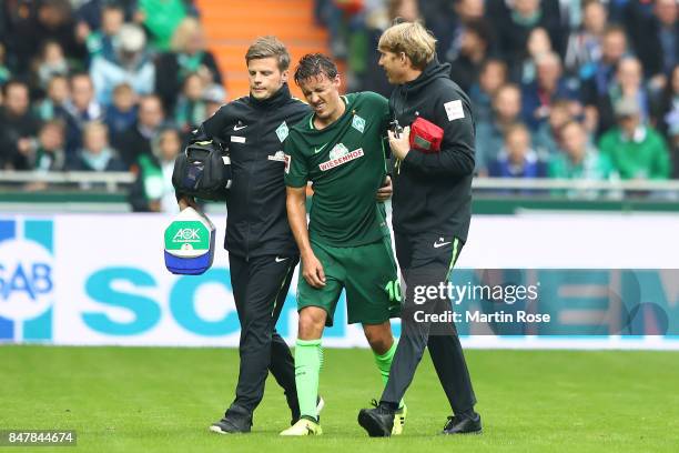 Max Kruse of Bremen has to leave the match injured during the Bundesliga match between SV Werder Bremen and FC Schalke 04 at Weserstadion on...