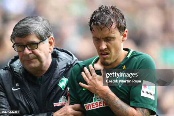 Max Kruse of Bremen has to leave the match injured during the Bundesliga match between SV Werder Bremen and FC Schalke 04 at Weserstadion on...