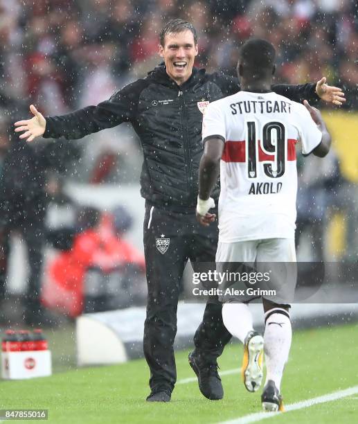 Coach Hannes Wolf of Stuttgart celebrates with Chadrac Akolo of Stuttgart after he scored his teams first goal to make it 1:0 during the Bundesliga...