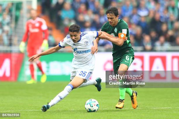 Amine Harit of Schalke fights for the ball with Thomas Delaney of Bremen during the Bundesliga match between SV Werder Bremen and FC Schalke 04 at...