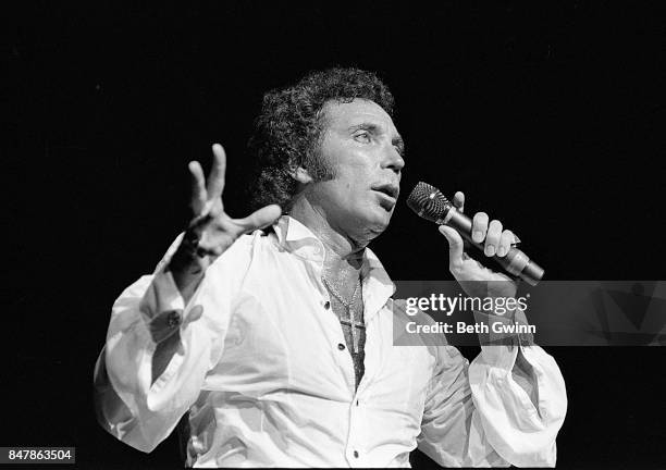 Welsh singer Tom Jones holds up a large pair of underpants while performing at the Grand Ole Opry on September 5, 1985 in Nashville, Tennessee.