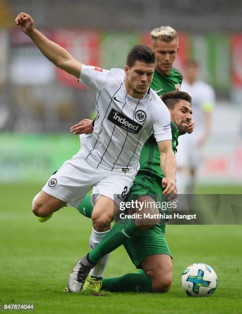 Luka Jovic of Frankfurt is challenged by Rani Khedira of Ausgburg during the Bundesliga match between Eintracht Frankfurt and FC Augsburg at...