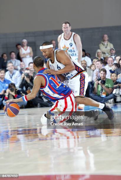 Handles Franklin of the Harlem Globetrotters dribbles against Actor Donald Faison during the McDonald's All-Star Celebrity Game on center court...