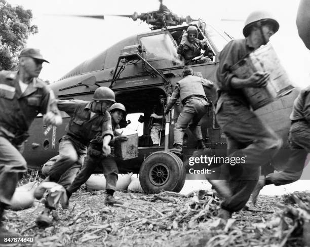 Picture released on May 27, 1964 of a US helicopter landing to allow American and vietnamese soldiers to unload resupplying in the Southern Vietnam...