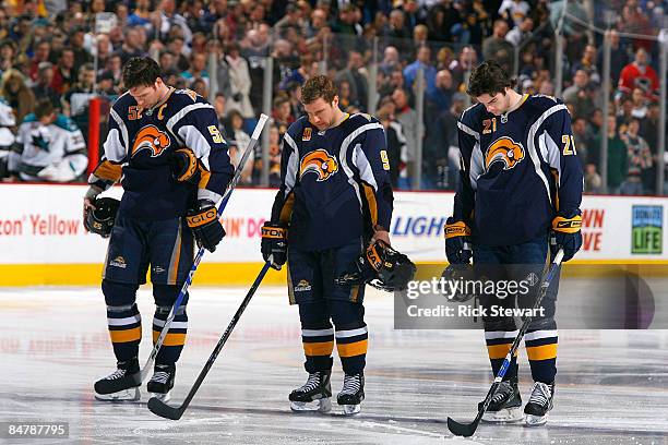 Craig Rivet, Derek Roy and Drew Stafford of the Buffalo Sabres pause for a moment of silence for the victims of Continental Connection flight 3407...